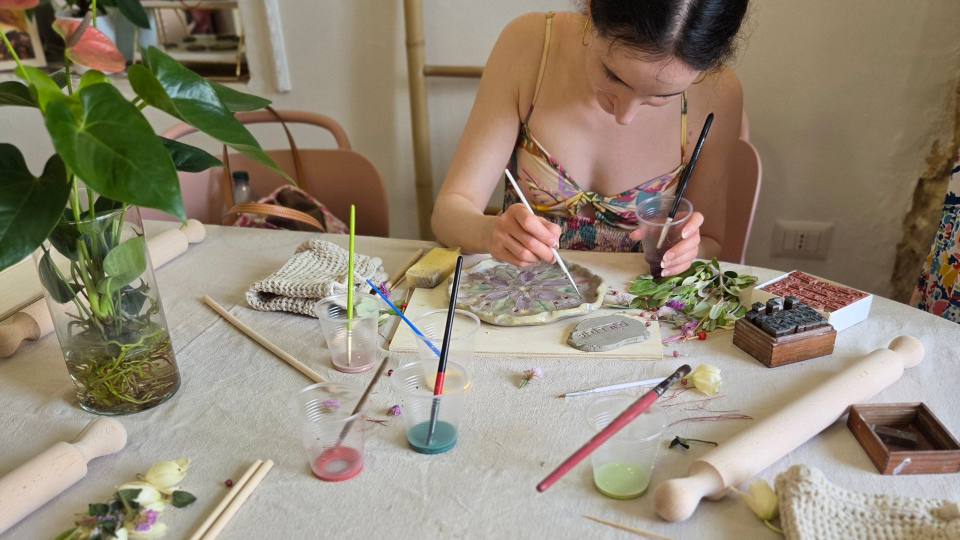 Painting a ceramic slab in the studio