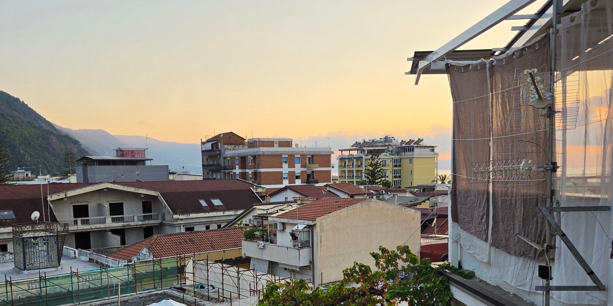 Rooftops and mountains at sunset in Bagnara